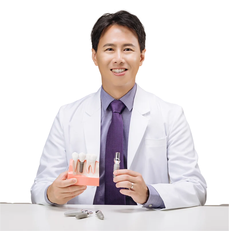 Dr. Daniel W.K. Kao holding a dental implant model